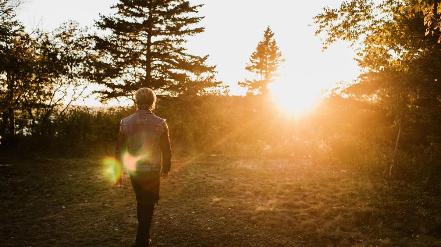 a man walking at sunset
