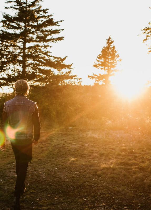 a man walking at sunset